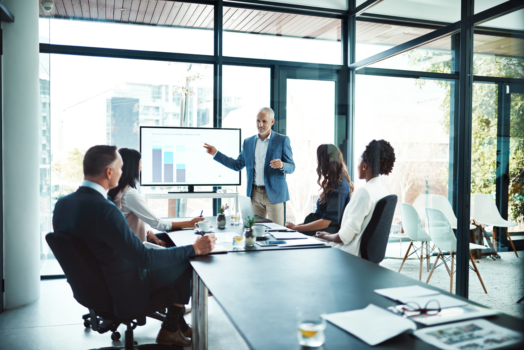 A man delivers a presentation to a group of people.